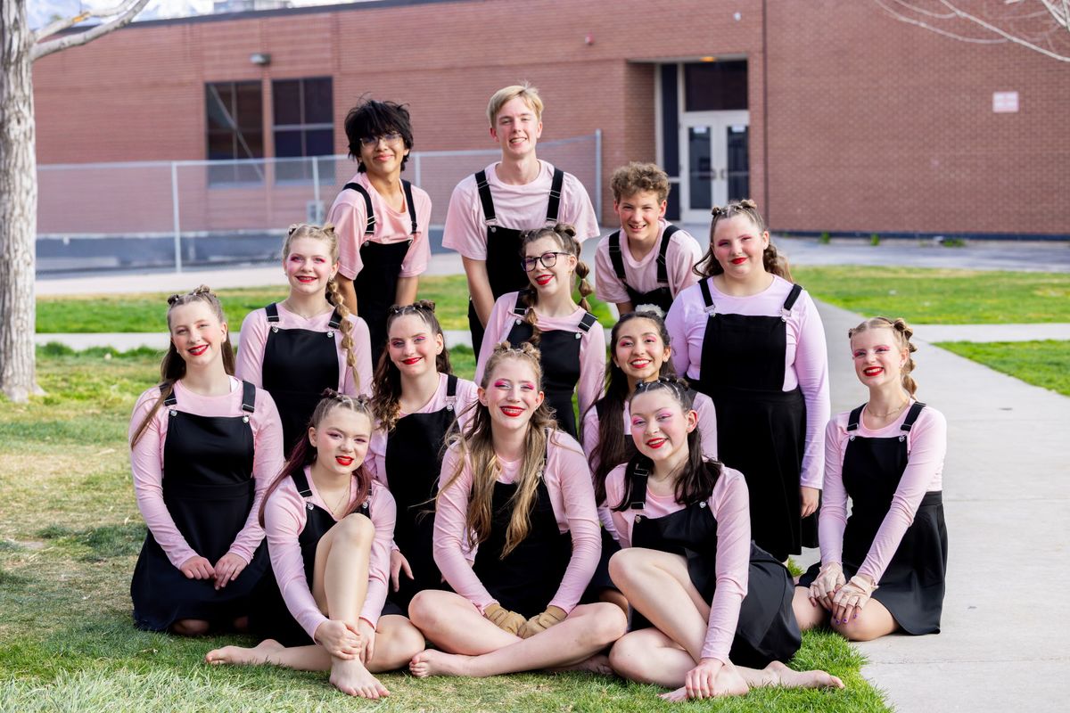 Lone Peak Color Guard junior varsity team in pink tops and black overalls