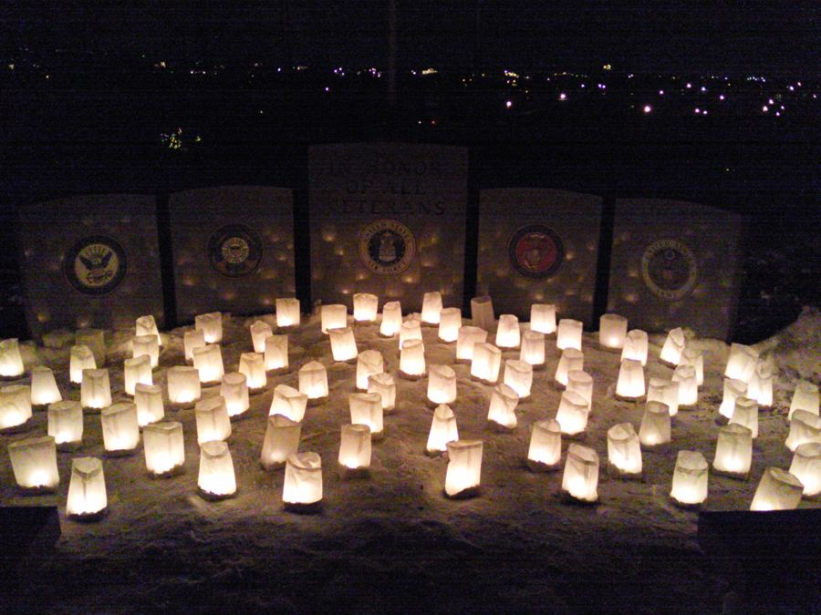 Luminaires glowing around the Alpine City Cemetery veterans monument